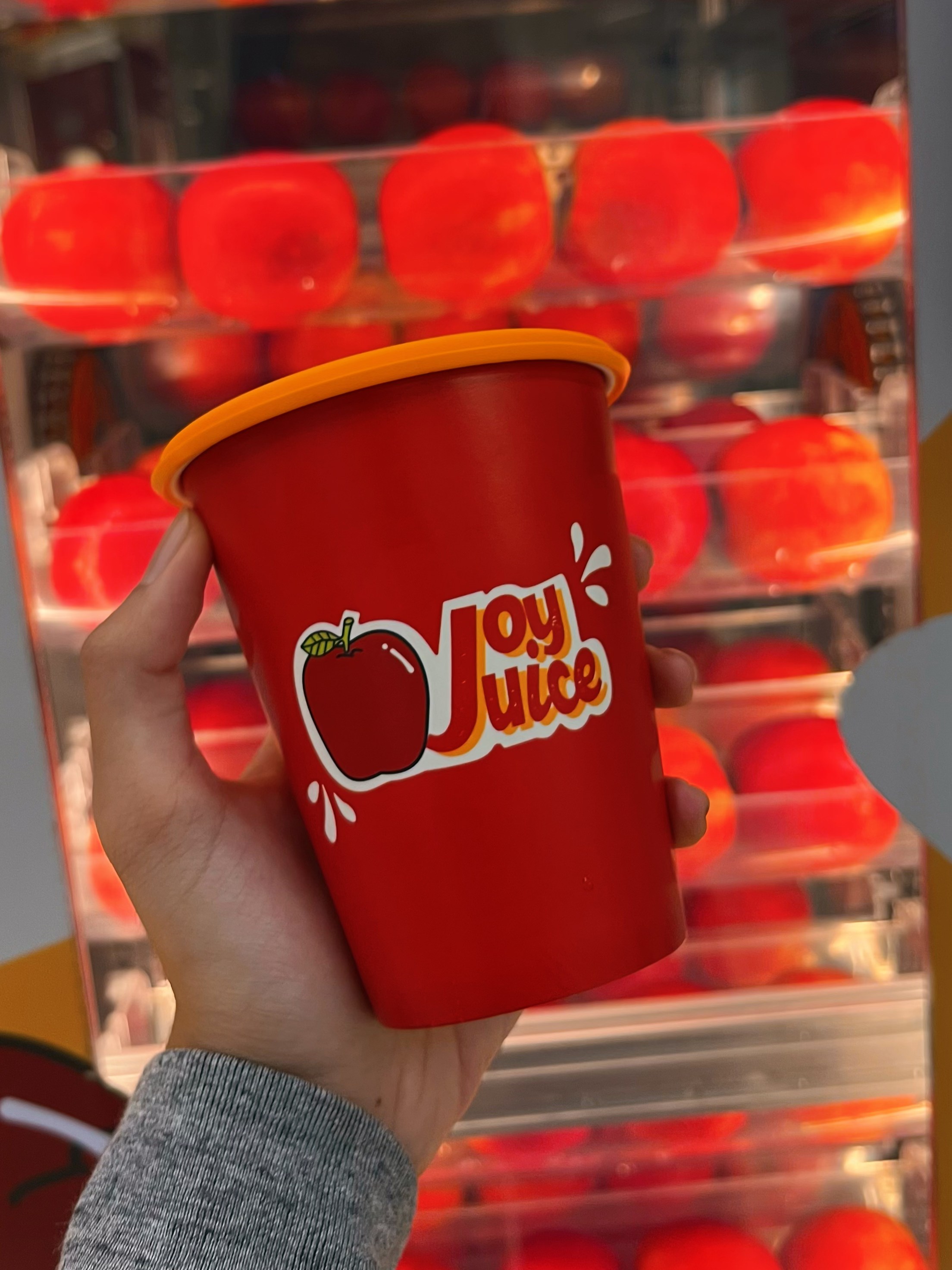JoyJuice branded cup with fresh apples