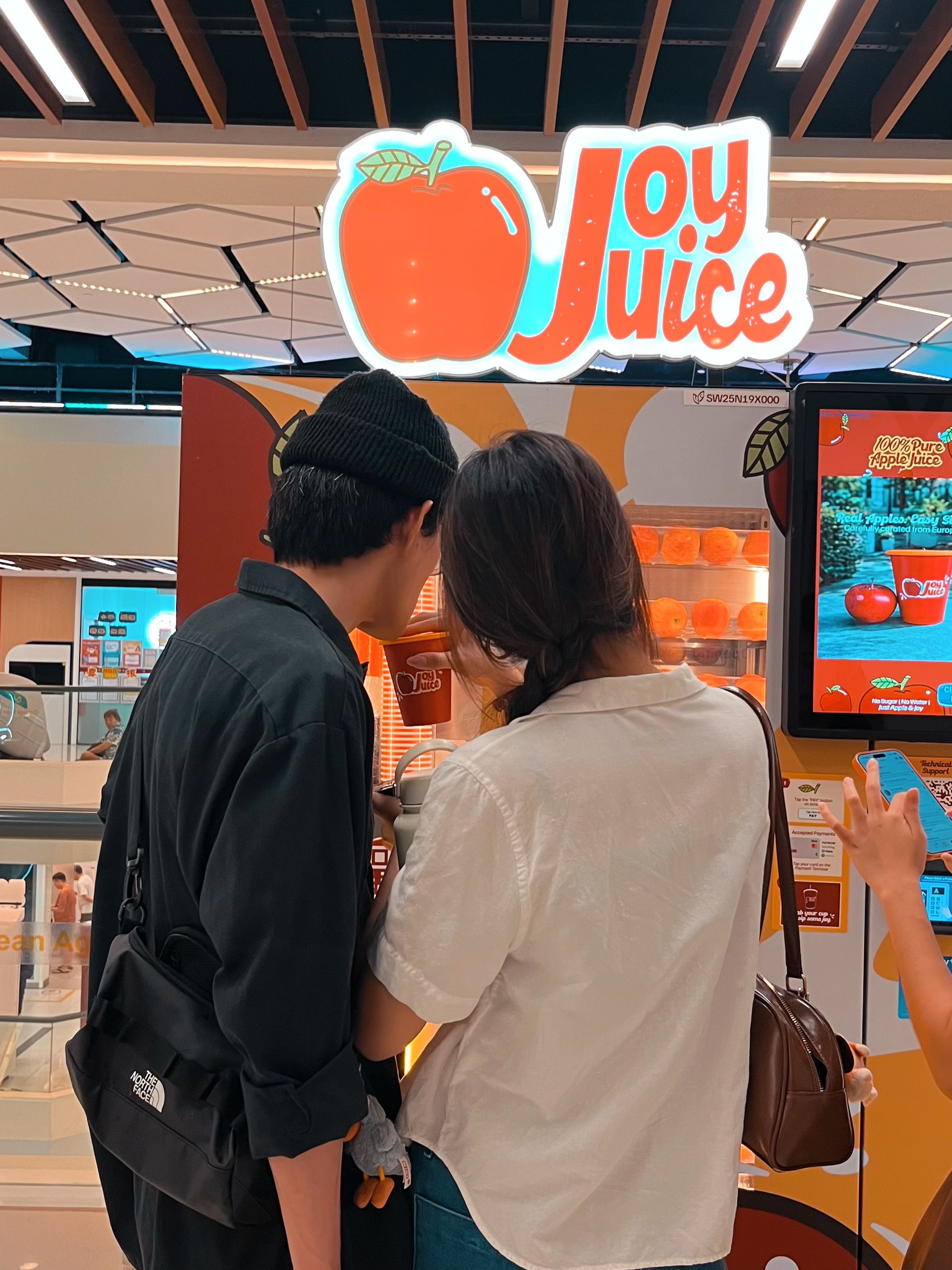 Customers using JoyJuice vending machine